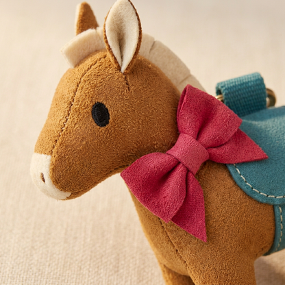 Caramel pony face cream mane and raspberry neck bow detail
