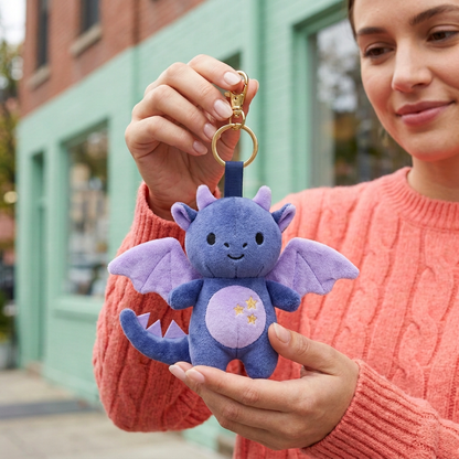 Female model holding Midnight Dragon charm with three lavender tail spines and gold-tone clasp